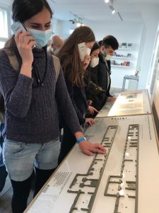 People standing next to a table are exploring a tactile map