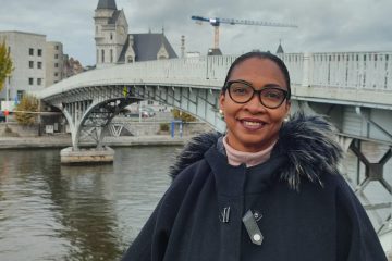 Marie-Claire Lavater posing for a picture in front of a bridge in Liège