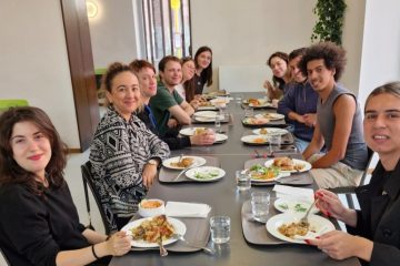 A group of participants, including Patricia, having lunch together