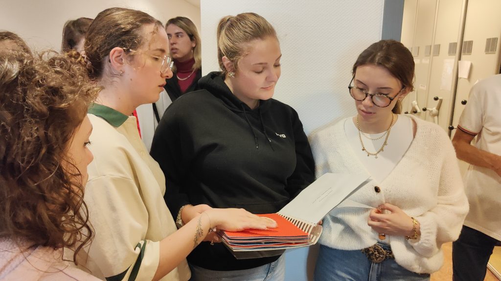 Four participants looking at an accessible book in Braille