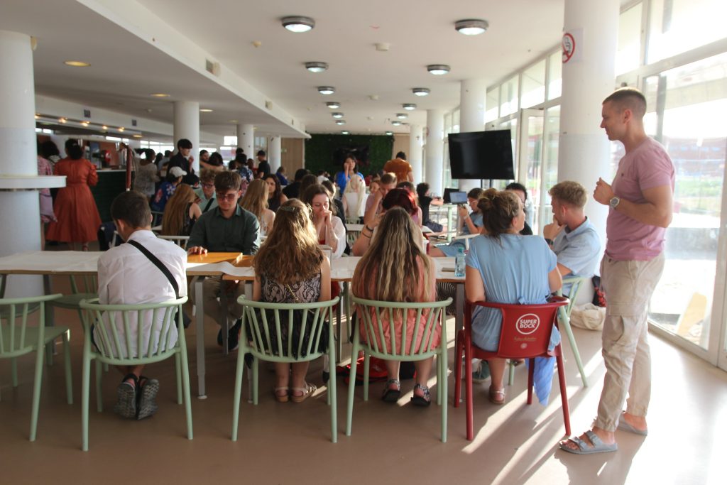 Participants sitting in the cafeteria, waiting for their meal