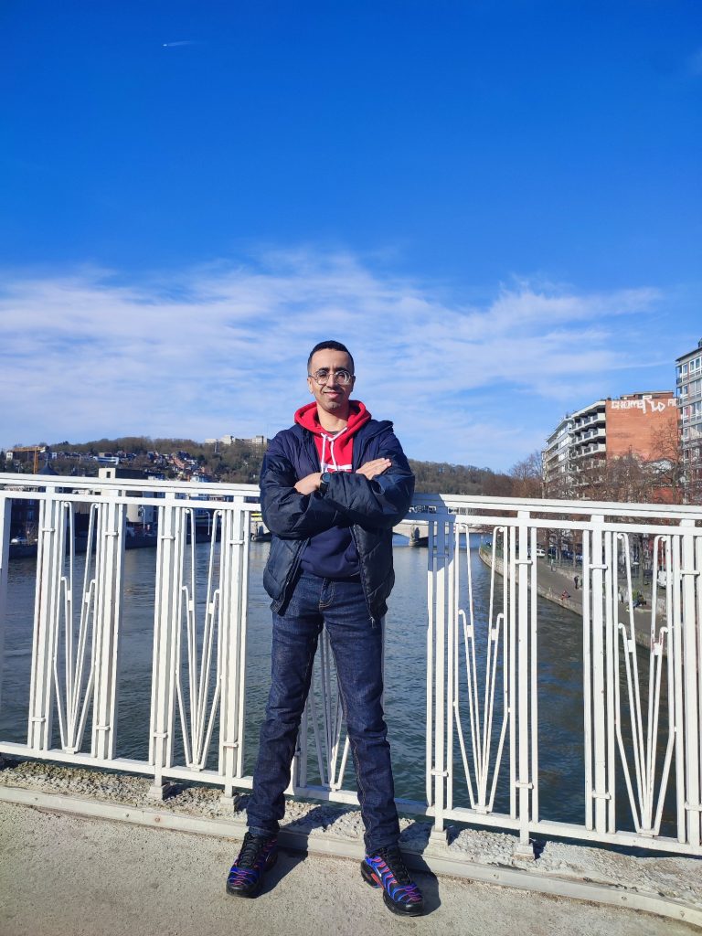 Youssef posing on a bridge in Liège